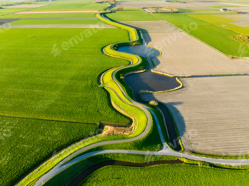 Preview: An aerial view of a road with curves. Road through the field. Image for wallpaper and background