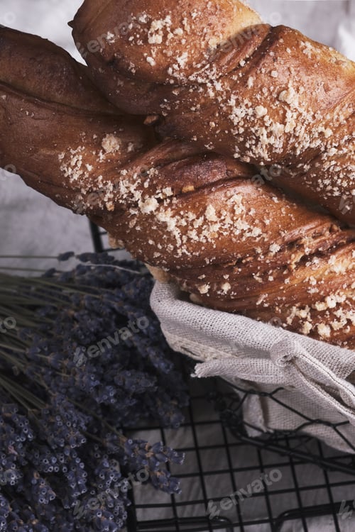 Preview: White bread in a basket and lavender flowers in vintage style.