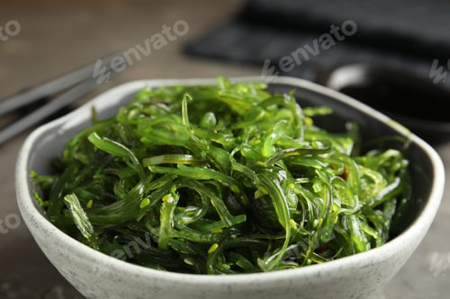 Preview: Japanese seaweed salad served on grey table, closeup