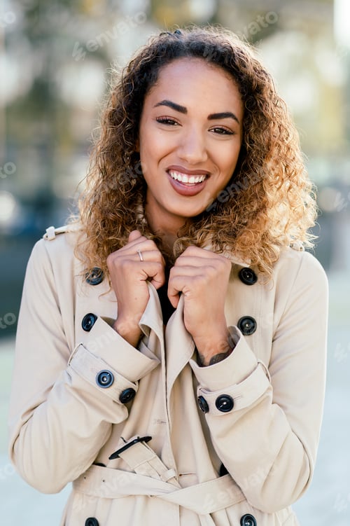 Preview: Happy woman with curly hair on street