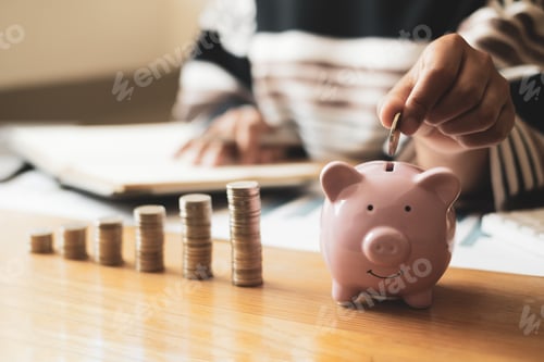 Preview: Woman's hand. putting coins in the piggy bank with coins, saving money with coins, stepping into