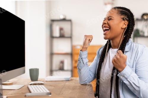 Preview: Black teen student lady celebrates achievement in front of computer