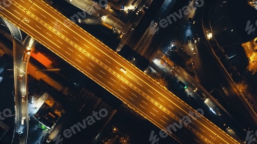 Preview: Top down night illuminate traffic highway aerial. Metropolis cityscape with modert neon road
