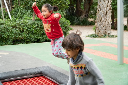 Preview: Multiracial children jumping on trampoline on Christmas holidays