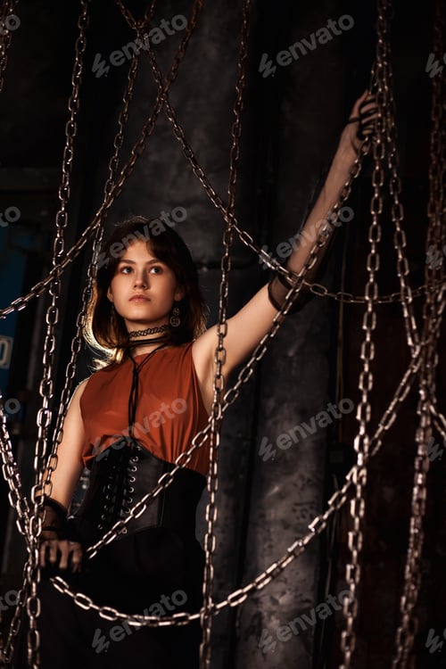 Preview: Stylish teen girl model 15-16 year posing in dark industrial room, looking away
