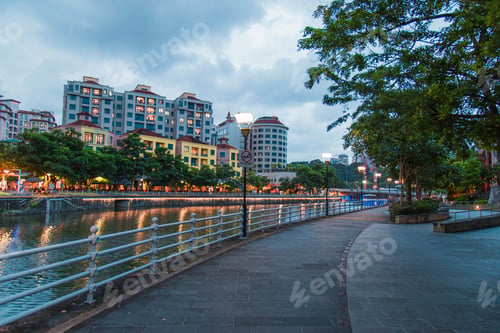 Preview: General view from Singapore skyscrapers and flats among green streets during twilight