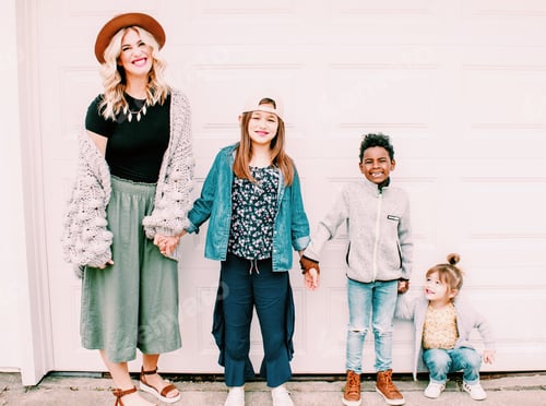 Preview: Woman and Children Standing Together in a Suburban Setting