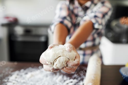 Preview: Cropped shot of an unrecognizable girl having fun while baking in the kitchen at home