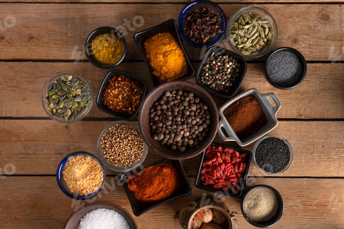 Preview: Bowls of spices placed in the center of a wooden table