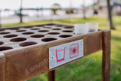 Preview: Close-up of storage table for empty glasses on the beach.
