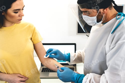 Preview: Doctor doing medical injection syringe vaccine to young patient in hospital