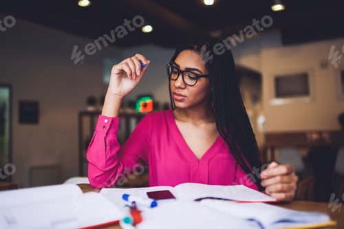 Preview: Serious black woman doing study task