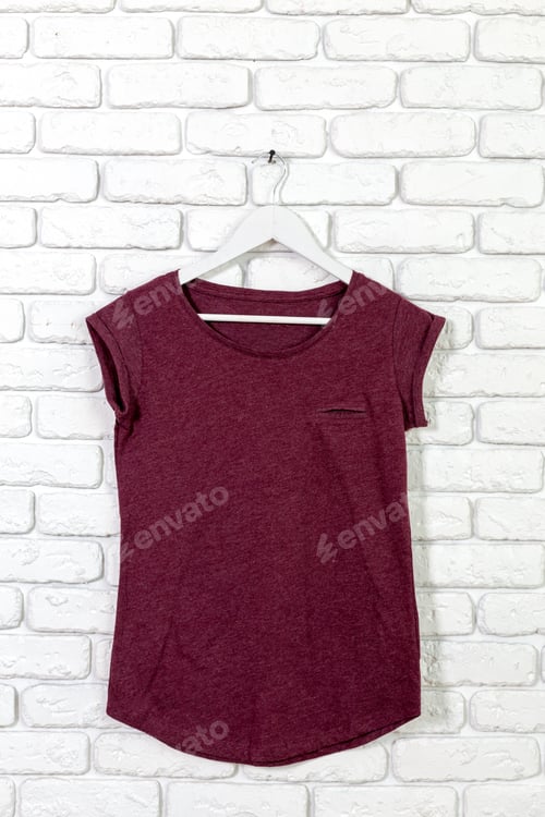 Preview: T-Shirt on Hanger Against Brick Wall