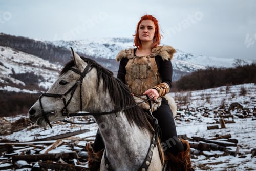 Preview: Beautiful girl on horse and with red hair in armor. Woman is a Viking. Fantasy