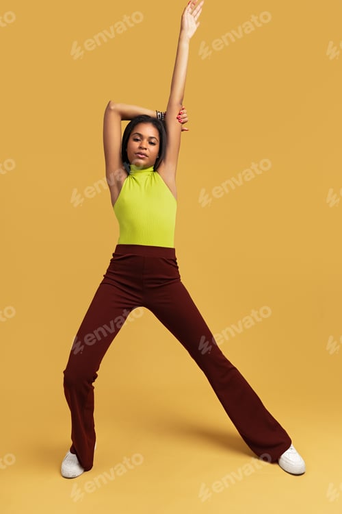 Preview: Trendy Hispanic woman raising arm
