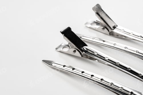 Preview: Close up of metal hair clips isolated on white background
