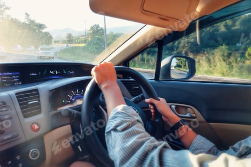 Preview: A person driving a car to work