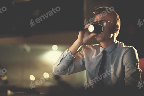 Preview: Tired businessman working late