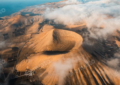 Preview: Volcanoes in Lanzarote at sunrise. Aerial view of Caldera Riscada. Canary Islands, Spain