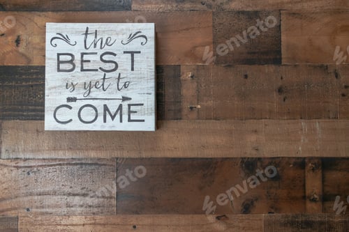 Preview: Motivational Sign Against a Wood Panel Wall