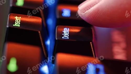 Preview: Person is in doubt whether to press the Delete key or not. Heavy decision do it or not.