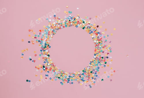 Preview: Sequins multicolored confetti lined round frame pink background. Abstract festive composition place