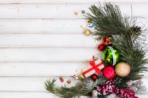 Preview: Christmas gift box and branch christmas tree and ball toy and cone on white wooden background