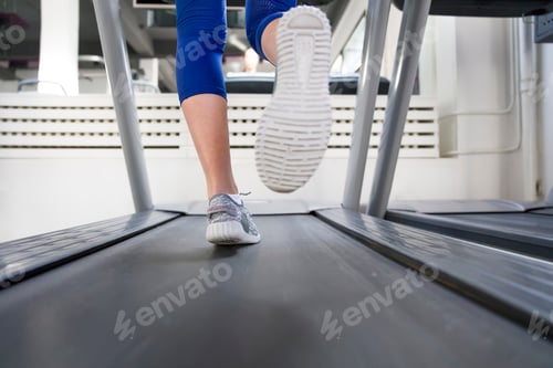 Preview: Fitness girl running on treadmill
