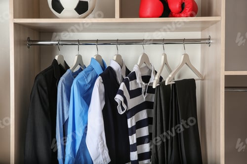 Preview: Clothing Hanging in a Closet with Sporting Goods