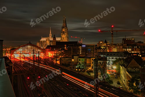 Preview: Cologne Cathedral and railway station at night with light trails.