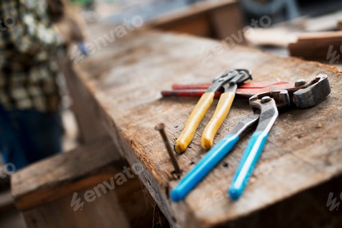Preview: Reclaimed lumber workshop,person at a workbench with tools,grippers,pliers and planks