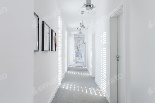 Preview: Long white corridor with modern lightning and armchair