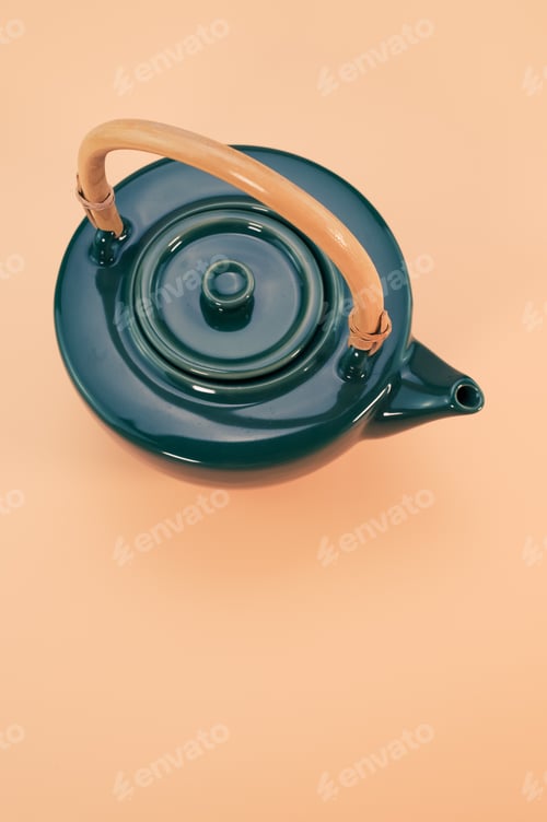 Preview: Vertical shot of a beautiful kettle on a coral background