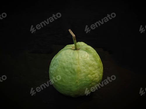 Preview: a guava is displayed on a black background with its shadow from it