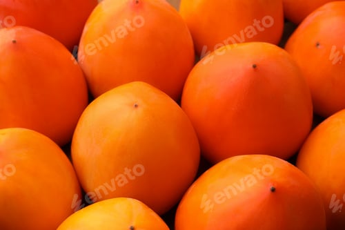 Preview: Pile of delicious ripe juicy persimmons as background, closeup