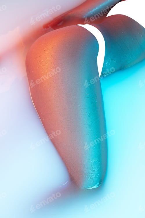 Preview: Close up female body in the milk bath with soft glowing in neon light