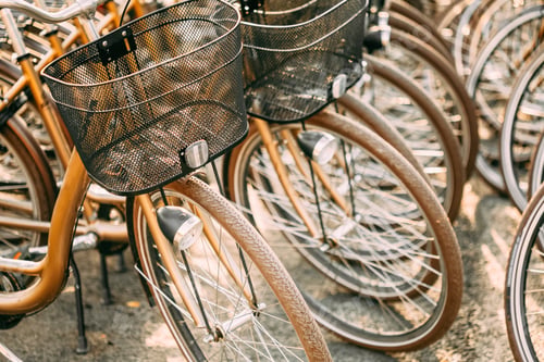 Preview: Close Up Of Wheel Of Bicycles On Parking In City. Sunlight Sunsh