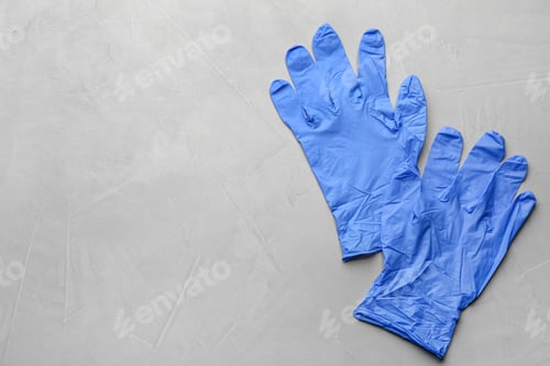 Preview: Pair of medical gloves on light grey background, flat lay. Space for text