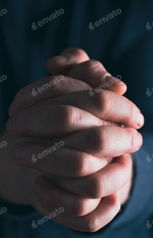 Preview: Man hands in praying position low key image