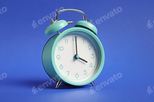 Preview: One turquoise alarm clock on blue background