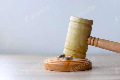 Preview: Side view of judge gavel and rings for divorce concept