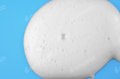 Preview: Macro photo of white shampoo or detergent foam on blue background