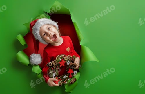 Preview: girl in Santa's hat on bright color background