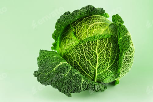 Preview: Fresh ripe savoy cabbage isolated on light green background. Close up wallpaper.