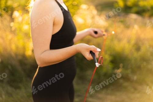 Preview: Beautiful and sporty girl is engaged in fitness. Exercise outside. Healthy lifestyle.