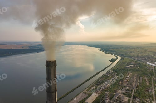 Preview: Aerial view of high chimney pipes with grey smoke from coal power plant. Production of electricity