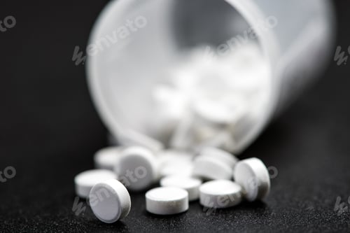 Preview: Medical white pills for the treatment and health care on a black background.