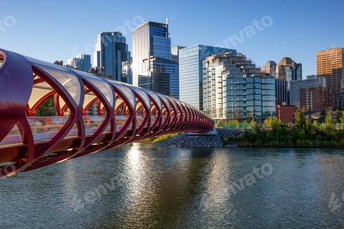 Preview: Peace Bridge across Bow River during a vibrant summer sunrise