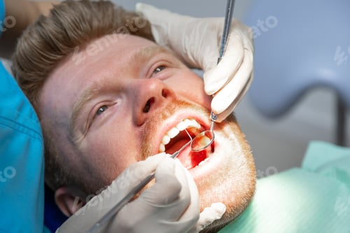 Preview: Man receiving dental examination during routine checkup