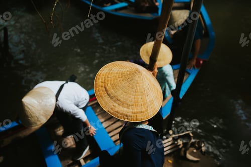 Preview: Vietnamese people with nón lá leaf hats trying to get out from the blue boats in Meckong Delta